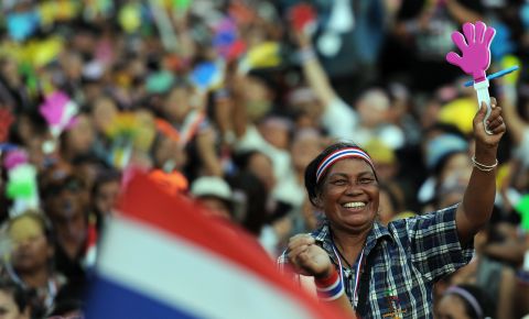 A Thai opposition protester waves a clapper during a rally at Bangkok's Democracy Monument Sunday.