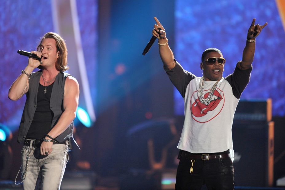 Tyler Hubbard, left, of the musical group Florida Georgia Line performs on stage with rapper Nelly.