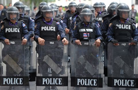 Thai riot police stand guard in Bangkok on Monday in an escalation of mass street rallies aiming to topple Prime Minister Yingluck Shinawatra's embattled government.