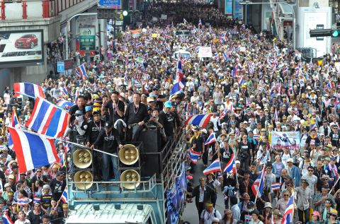 Demonstrators wave national flags during a rally in Bangkok on November 25, 2013.