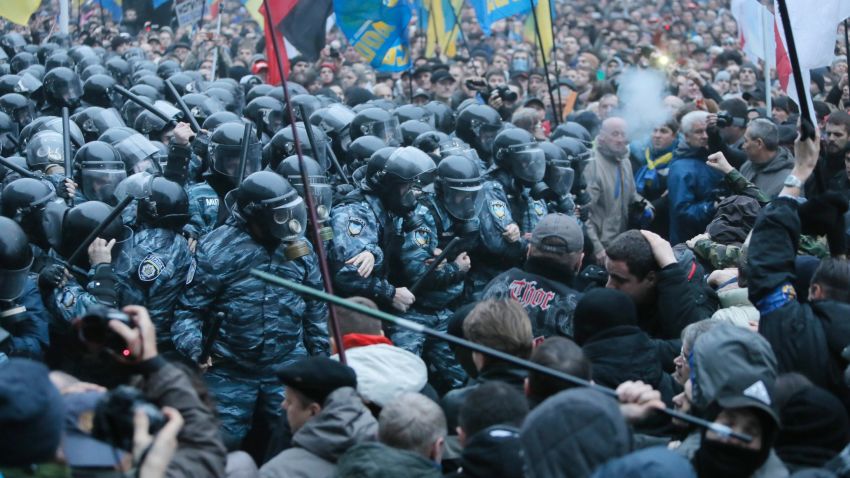 Opposition protesters and riot police clash in front of the Ukrainian Cabinet of Ministers in Kiev, Ukraine, Sunday, Nov. 24, 2013.