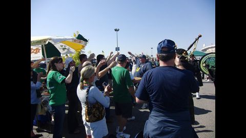 Wolnitzek, center right in the Notre Dame apron, leads a toast during his tailgate. 