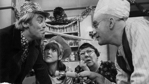 Alf Garnett (Warren Mitchel) and son-in-law Mike (Anthony Booth) argue during Christmas dinner in the BBC's "Till Death Do Us Part."