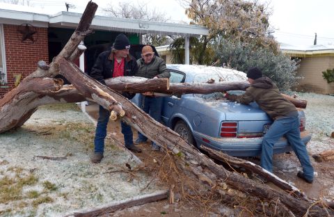 A fallen tree is removed from a car in Odessa, Texas, on November 25.
