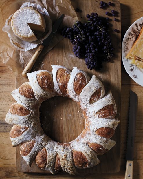 A circular loaf mimics the look of the corn-husk wreath—and a clever cutting technique creates radiant sections. When it's time to eat this centerpiece-worthy bread, it easily breaks into perfect portions.<strong>Supplies: </strong>Bread dough, All-purpose flour, Scissors<strong>How-to:</strong> 1. Punch into center of dough and make a hole, using your fingers to pull dough into a ring shape. 2. Generously dust top of dough with flour. Holding scissors at a 45-degree angle, snip a deep V into top of ring. Repeat every inch or so around ring. 3. Gently lift each snipped portion and splay outward, creating rays. Bake wreath.