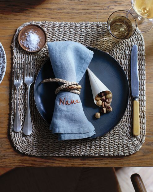 Round out place settings with individual horns of plenty—wood-veneer cones filled with nuts.