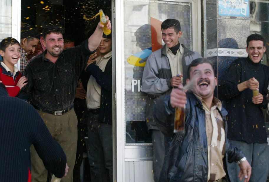Iraqis celebrate in Nasiriyah, Iraq, after Hussein's capture.