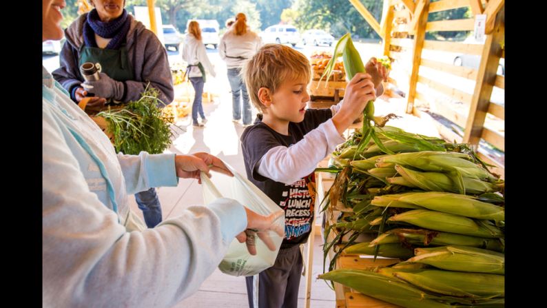 Benjamin Beall, 9, shops at the Sow Much Good market with his mother and sister.