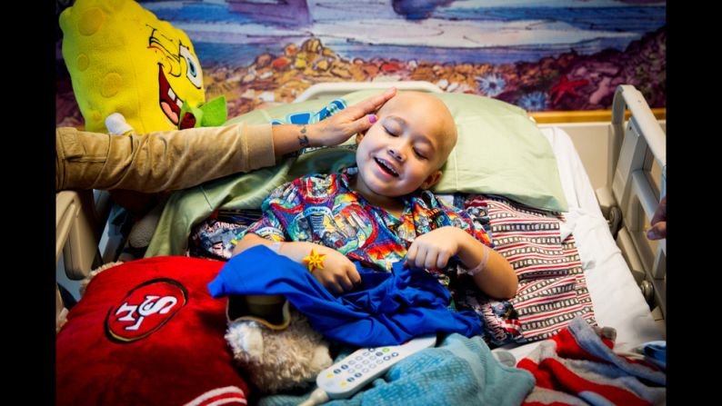 A young patient holds his "Loving Tabs" T-shirt.