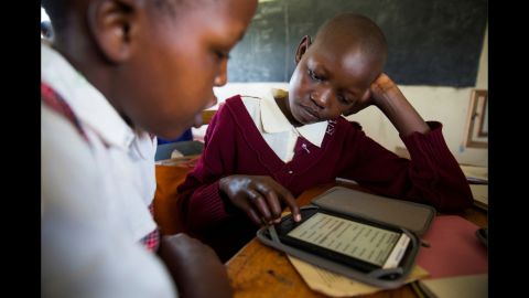 Girls at the school learn how to use the e-readers that were recently donated.