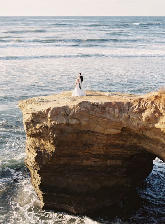 For this California wedding, newlyweds were photographed on dramatic coastal bluffs. "The rocky path down the cliff in this photo was not the most convenient nor high-heel friendly, but the bride took off her shoes to walk down the cliff," says Bryce Covey of Bryce Covey Photography. "It resulted in one of their and my own favorite photos of the wedding day!" 