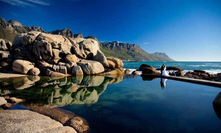 Photographer Greg Lumley took this shot at a tidal pool in Cape Town after the ceremony and on the way to the reception. "I had chosen this spot specifically because of the dramatic boulders and glass-like pool edging the ocean," says Lumley. "The fact that the 12 Apostles -- part of Table Mountain -- were in the shot turned out to be total bonus, as I'd not noticed them before."      