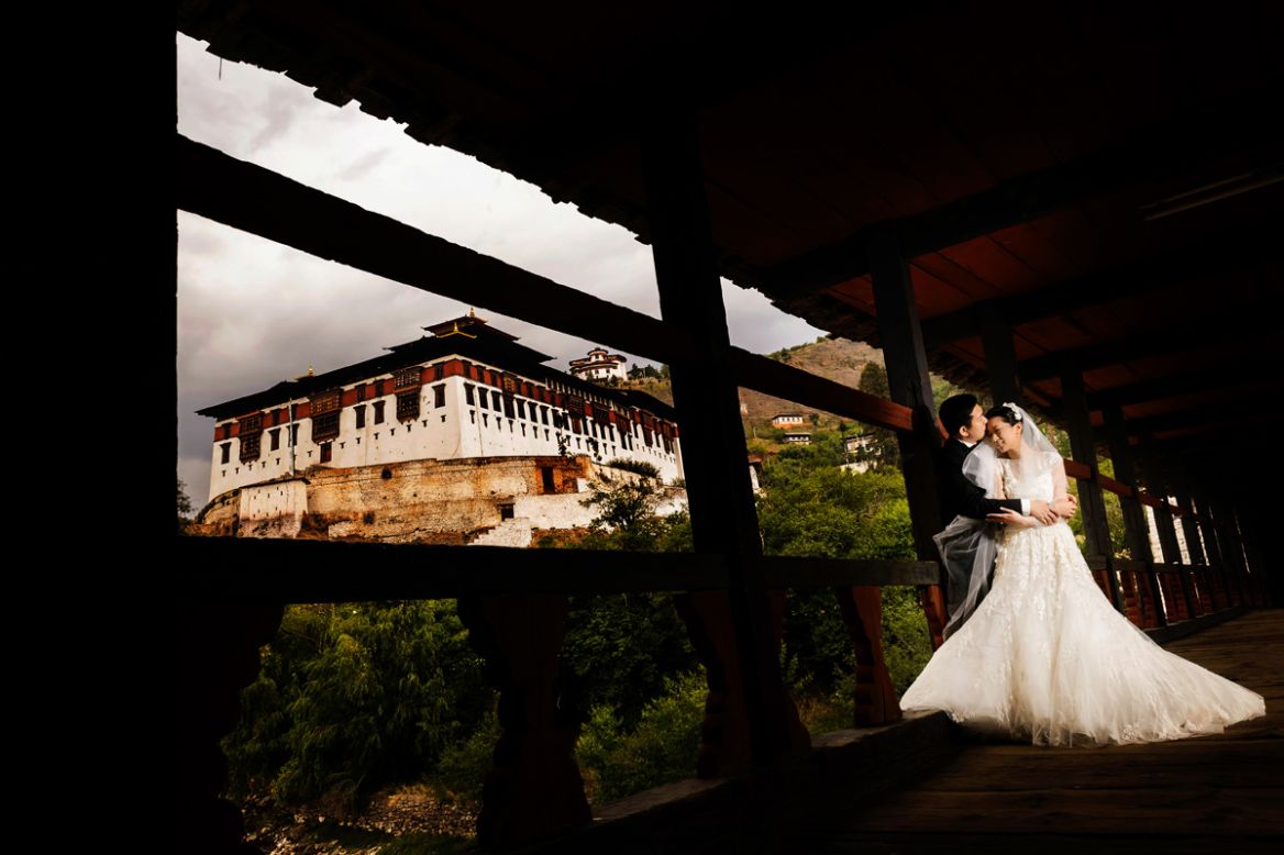 Taiwanese couple Christine and Chiaming flew to Bhutan for their wedding. "Christine loved the architecture of the traditional homes and temples, so it was important to us to show both the landscape and the architecture in the photos," says Ben Chrisman of <a href="http://chrismanstudios.com" target="_blank" target="_blank">Chrisman Studios</a>, who took their wedding pics. "You have to really show what makes the place unique. You don't want the wedding photos to look like they could have been shot anywhere."