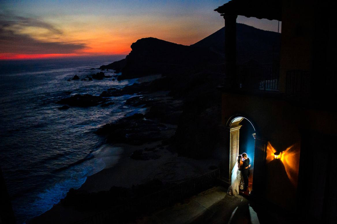 Todos Santos is a laid-back beach town north of Cabo San Lucas. Despite a late ceremony time, Chrisman was determined to capture a dramatic sunset. "A bit of flash helped illuminate Apollina and Brad, and the light on the side (of the Hacienda Cerritos) balanced nicely with the colors of the sunset," says Chrisman. 