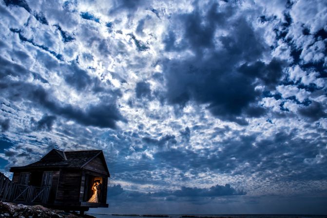 While choosing Half-Moon Resort for their wedding, one couple noticed this little hut, actually a massage room for the hotel's spa. "We had a limited amount of time for portraits before the ceremony, so we were rushing around trying to hit all the desired spots," says Chrisman. "This photo captures the dramatic, cloudy sky we had that day."