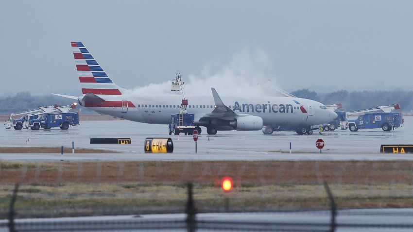 Crews spray deicing solution onto an American Airlines 737 before departure at Dallas-Fort Worth International airport, Monday, Nov. 25, 2013. Winter weather has caused travel disruptions throughout the area including the cancellation and delays of hundreds of flights. (AP Photo/Brandon Wade)
