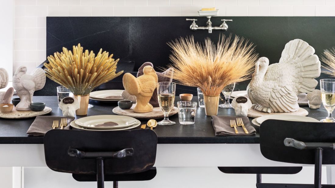 The overall look of the tablescape is casual but inviting, and it is perfect for guests of all ages. The centerpieces are full but unfussy—bunches of Timothy grass, wheat, and foxtail gathered in gold lusterware cups. They alternate with old English carved breadboards, which hold the turkey sculptures, as well as various small stone vessels for salt and pepper. The only linens on the table are the napkins, which were made from beautiful linen yardage from a shop in Wiscasset, Maine.