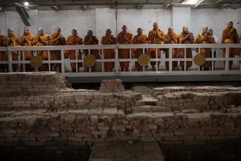 Thai monks inside the Maya Devi Temple meditate over the remains of the oldest Buddhist shrine.