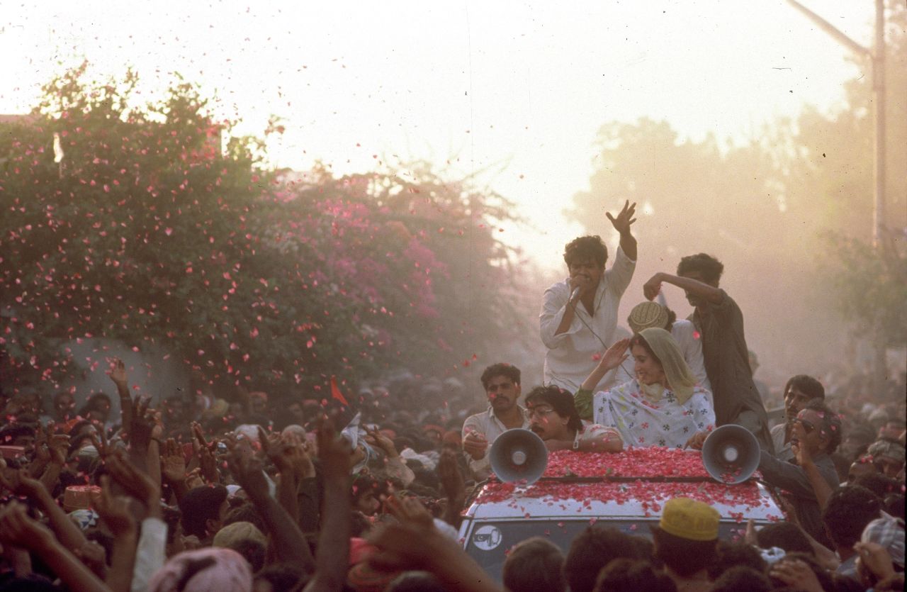 Crowds of supporters throw rose petals to greet Bhutto during the election campaign against President General Muhammad Zia-ul-Haq for the position of prime minister in October 1986 in Sindh, Pakistan.