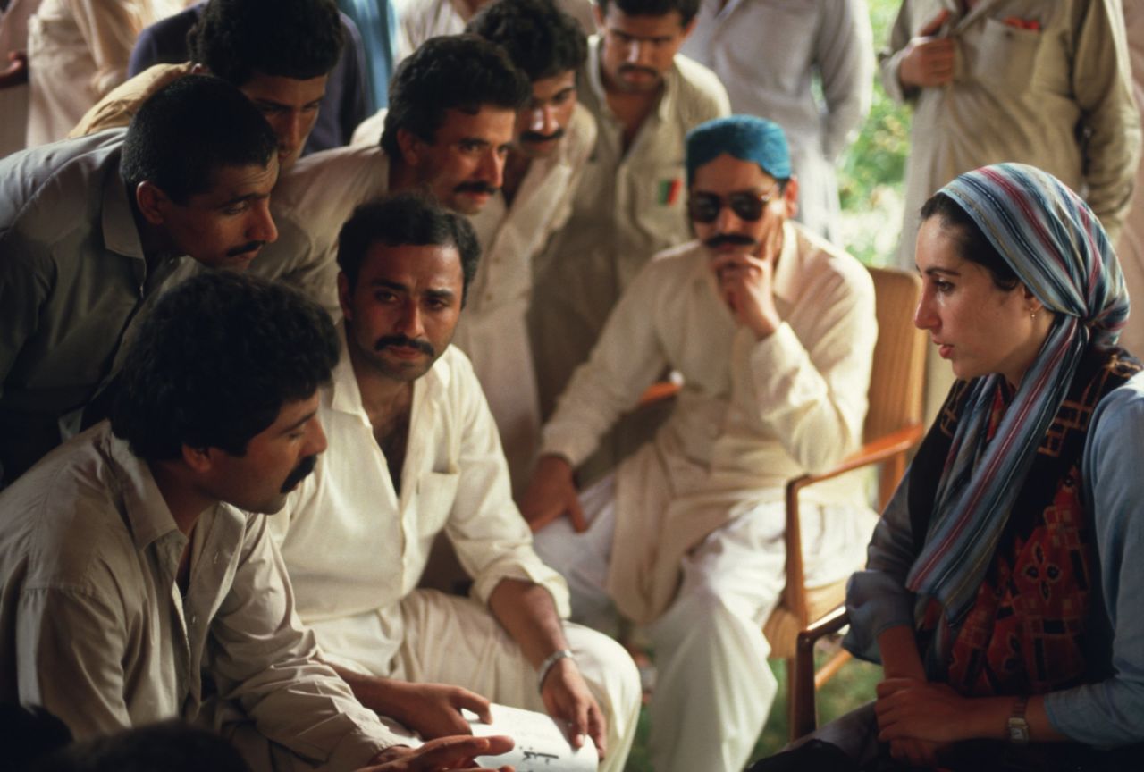 Bhutto meets with a group of male supporters at her family home in Larkarna after returning to Pakistan from London to lead her late father's party, the Pakistan People's Party, in 1986.