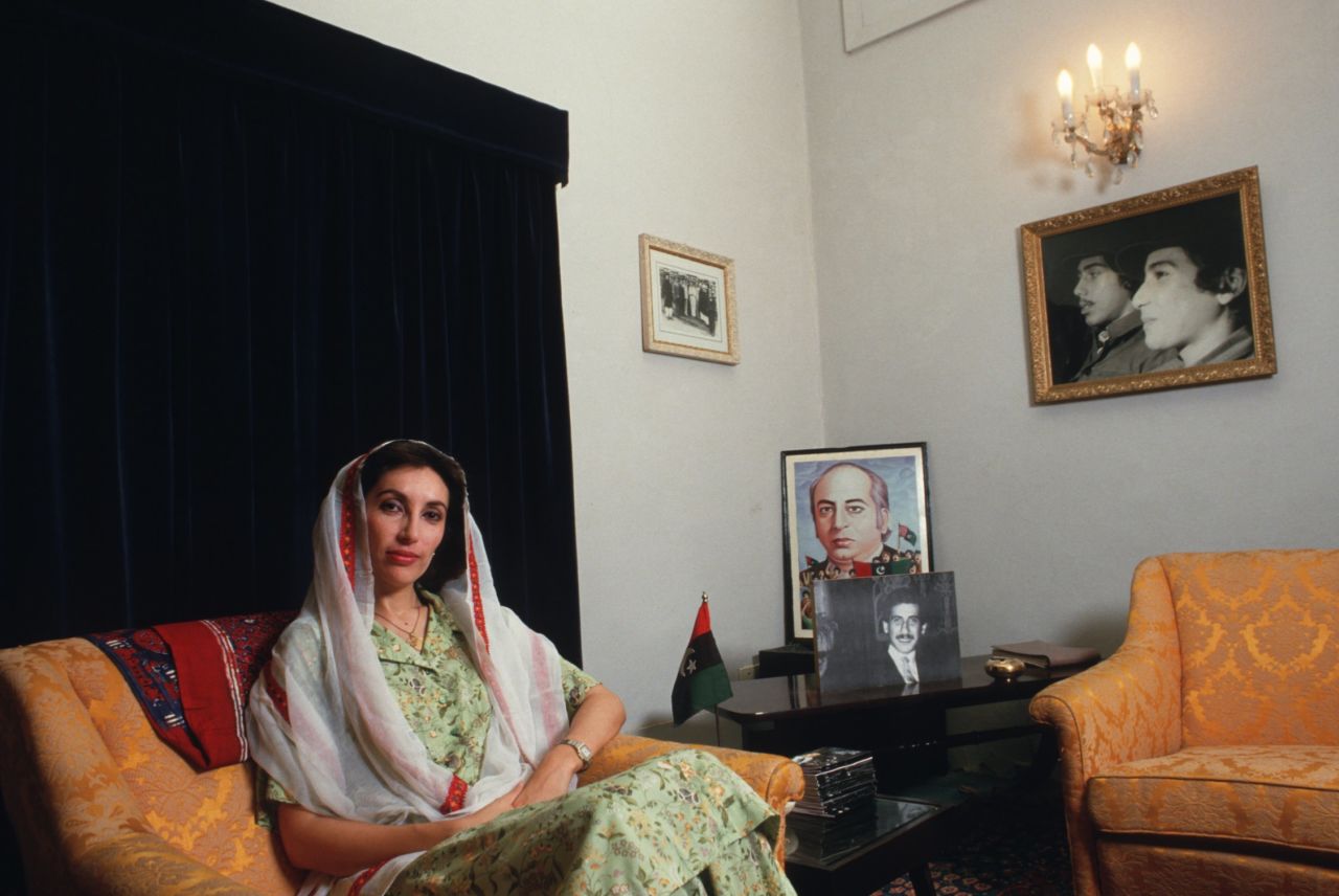 Bhutto at her family's home in Larkarna. Behind her is a picture of her father, Zulfikar Ali Bhutto, who in 1979 was hanged for the murder of a political opponent two years after he was ousted as prime minister in a military coup.