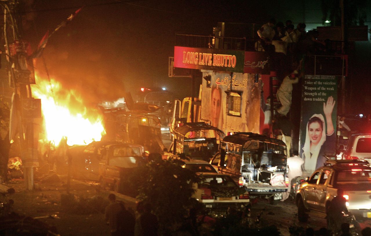 A Pakistani court finds Bhutto guilty of corruption and sentences her to five years in prison. The conviction is later overturned, but she remains in exile. Bhutto returns to Karachi in October 2007 and narrowly escapes injury as a suicide bombing near her convoy kills 136 people.