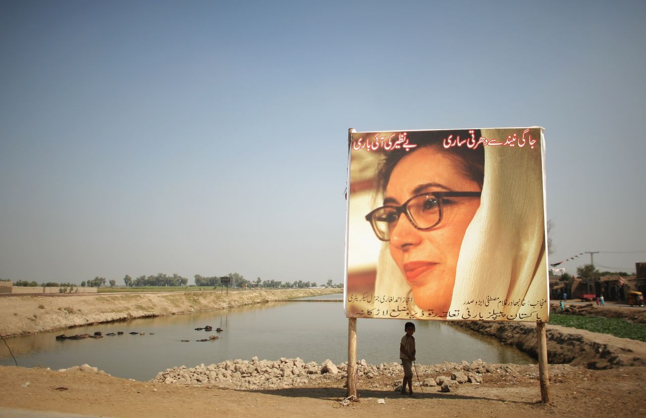 A boy stands underneath a billboard of Bhutto in Larkana on October 23, 2007. A month later Bhutto was fatally injured when a gunman fired shots then detonated a suicide bomb during a rally in Rawalpindi. In August 2013, a Pakistani court indicted President Pervez Musharraf in Bhutto's death.