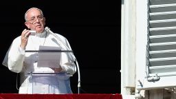 Pope Francis shows on November 17, 2013 a box containing a rosary during his Sunday Angelus prayer from the window of his appartment overlooking St.-Peter's square at the Vatican.