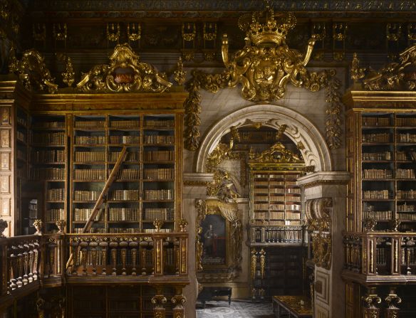 <strong>Will Pryce</strong>: "This is a very imposing library from a time when Portugal was extremely wealthy and powerful. It is very dark but features intricate gold leaf which gives it magical luminosity. The backs of the bookcases each have different color, and there are integrated ladders that pull out, and secret doors that lead to reading rooms."