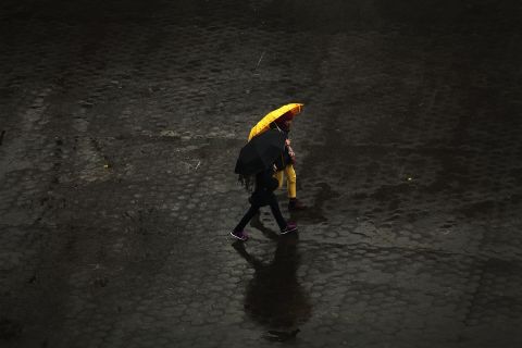 People walk in the rain through Union Square in Manhattan on November 26. New York was bracing for severe weather as the storm made its way east.