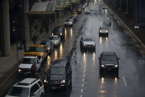 Vehicles pick up passengers in heavy rain at Reagan National Airport on November 26.