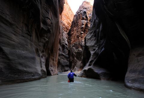 Zion National Park in Utah came in seventh place on the park service's list of most popular national parks. Here, a hiker wades up the Virgin River in the Zion Narrows. 