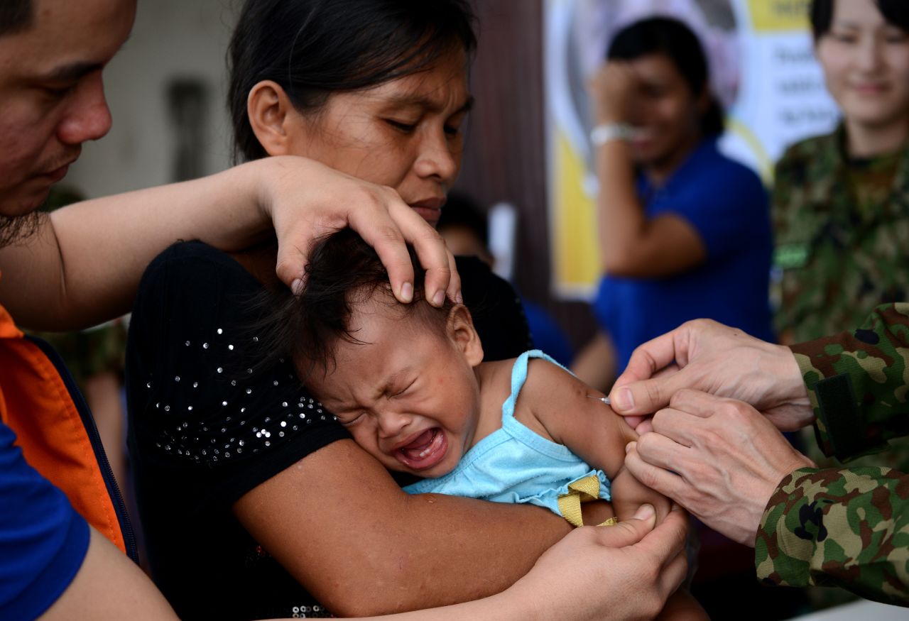A baby receives a measles vaccine in Tacloban, Leyte province, on Wednesday, November 27. Haiyan, one of the strongest storms in history, has affected 4.3 million people in the Philippines, and many of them rely on emergency relief for food and water. <a href="http://www.cnn.com/SPECIALS/impact.your.world/">See how you can help.</a>