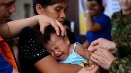 A baby receives a measles vaccine in Tacloban, Leyte province on Wednesday, November 27.