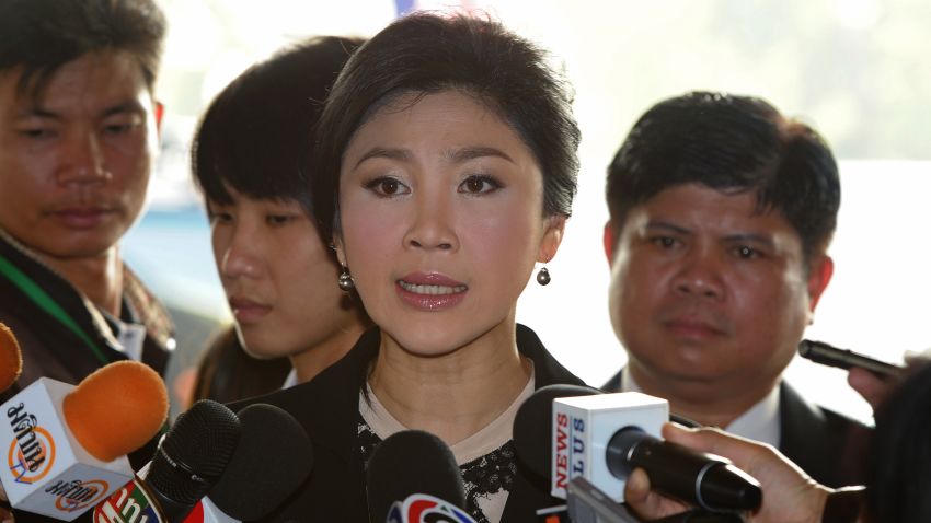 Thai Prime Minister Yingluck Shinawatra (C) answers a question from the media upon her arrival prior to a no-confidence debate at the parliament in Bangkok on November 26, 2013. Thailand's premier appealed for an end to 'mob rule' as she prepared to face a no-confidence debate in parliament after protesters occupied key ministries in a bid to topple her government. AFP PHOTO / PORNCHAI KITTIWONGSAKUL (Photo credit should read PORNCHAI KITTIWONGSAKUL/AFP/Getty Images)