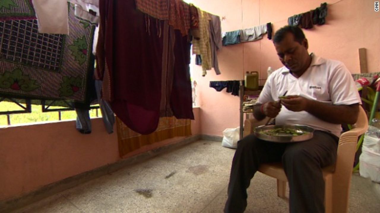Her father, Badrinath Singh cuts vegetables at his home in India.