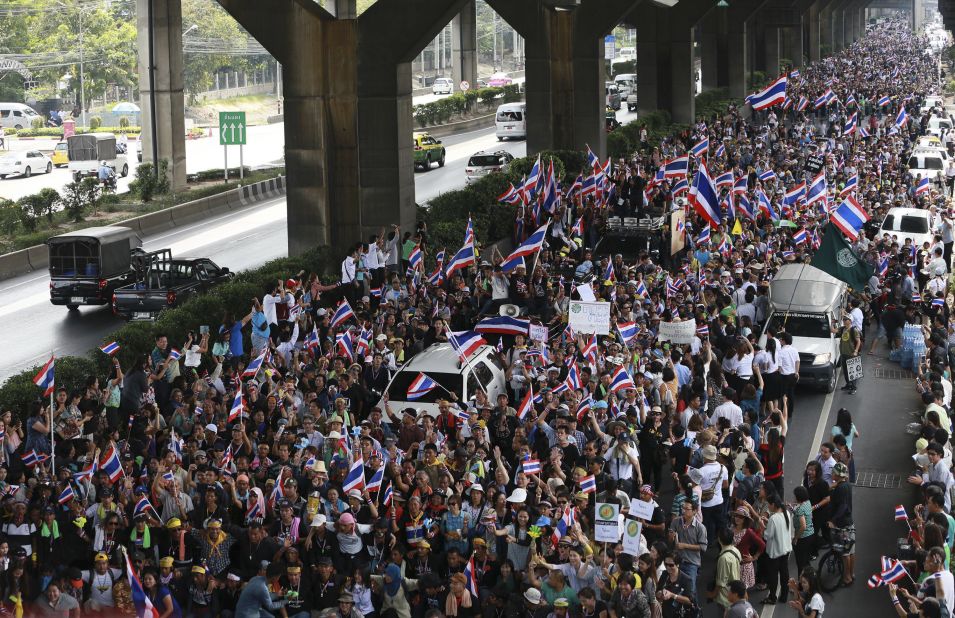 Flag-waving protesters vowing to topple the Thai prime minister took to the streets of Bangkok for a fourth day Wednesday, declaring they would take over "every ministry" of the government.