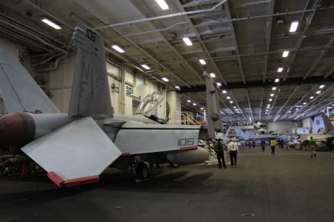 Below the flight deck, vital maintenance is carried out on aircraft in the carrier's giant hangers -- assets are lowered from the top deck on giant lifts.