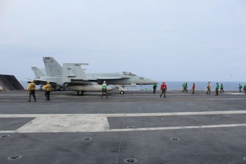 Crew working on the flight deck wear different colored vests according to the duties they peform, from refueling to maintenance.