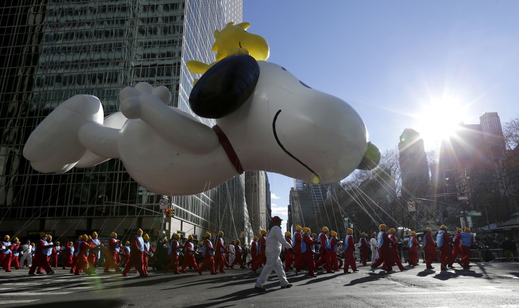 The Snoopy balloon floats down the street.