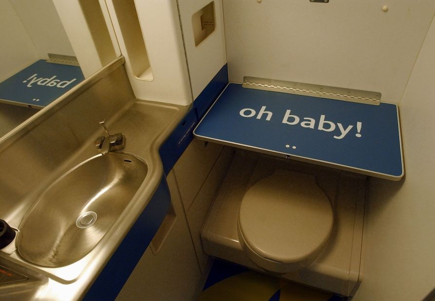Airplane changing tables are there for a reason -- to ensure you don't have to take care of baby's business at your seat.  