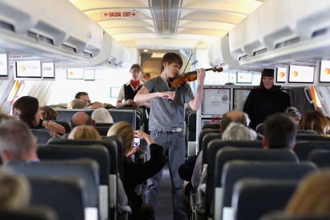 OK the violin we can probably deal with. In short bursts. But if he's about to launch into "Nessun Dorma," we have a problem. Amateur singing is not for planes. Or any small enclosed public space, for that matter. 