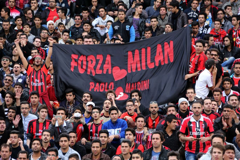 Iranian supporters of AC Milan welcome former players of the Italian soccer club for a charity match at Tehran's Azadi stadium. 