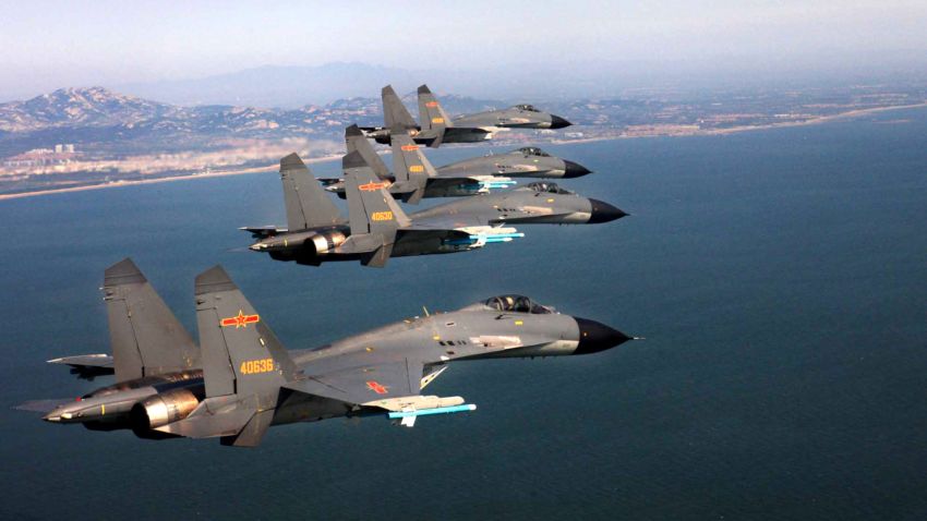 J-11 fighter jets of the Jinan Military Region of Chinas PLA Air Force fly over the sea during a combat training in east Chinas Shandong province, 16 September 2012.
China is stepping up live-ammunition combat trainings over islands dispute with Japan.