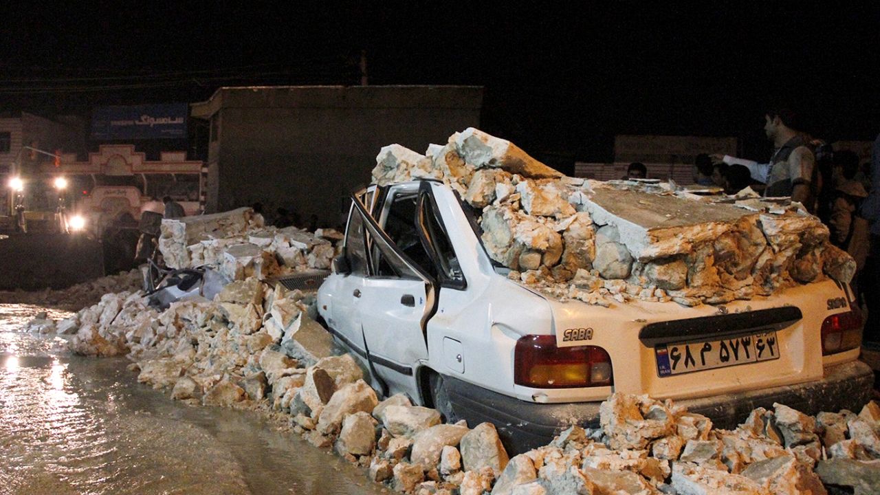 The wreckage of a car amid rubble in the Iranian western city of Borazjan, on November 28, 2013, after an earthquake struck the country, injuring at least 59 people.