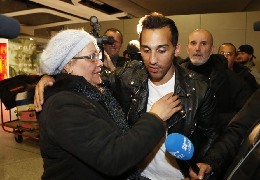 Football player Zahir Belounis (right) is welcomed by his mother as he arrives from Qatar at Paris' Roissy-Charles-de-Gaulle airport on November 28, 2013. 