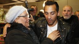 French football player Zahir Belounis (R) is welcomed by his mother as he arrives from Qatar at the French Roissy-Charles-de-Gaulle airport on November 28, 2013. The French-Algerian footballer, 33, has not been able to leave Qatar since June 2012, after he filed a complaint against his club Al-Jaish over a payment dispute. AFP PHOTO THOMAS SAMSON (Photo credit should read THOMAS SAMSON/AFP/Getty Images