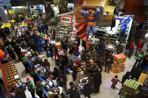 Customers wait in line to make their purchases at the Times Square Toys R Us on Thursday, November 28. More than a dozen retailers started their Black Friday sales early, opening on the evening of Thanksgiving.