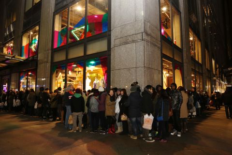Shoppers stand in line on Fifth Avenue in New York as they wait for stores to open November 29. 