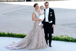 Crown Princess Victoria, Princess Estelle and Prince Daniel pose at a 2013 wedding.